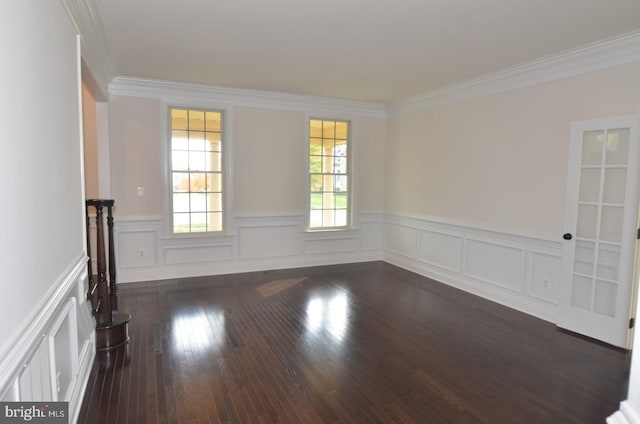 empty room featuring ornamental molding and dark hardwood / wood-style flooring