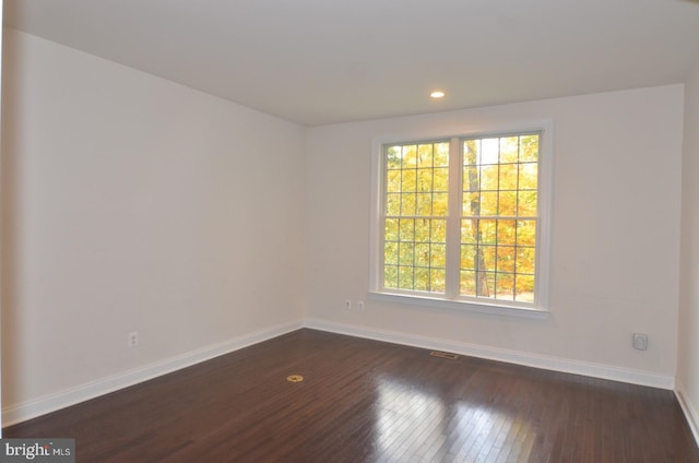 spare room with dark hardwood / wood-style floors