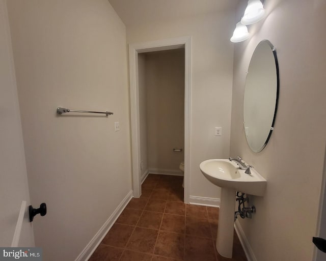 bathroom featuring toilet and tile patterned floors