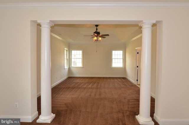 carpeted spare room with ornate columns, ceiling fan, and ornamental molding