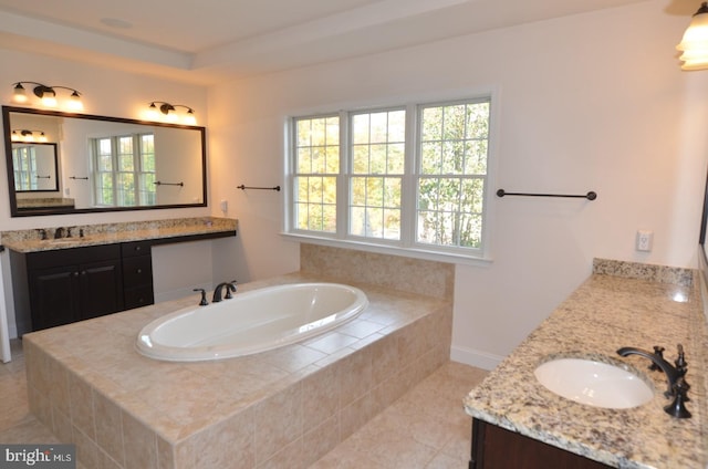 bathroom featuring vanity, a healthy amount of sunlight, tile patterned floors, and tiled bath