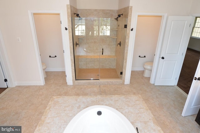 bathroom featuring toilet, tile patterned floors, and separate shower and tub