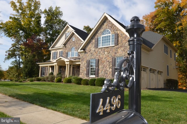 view of front of home featuring a front lawn and a garage