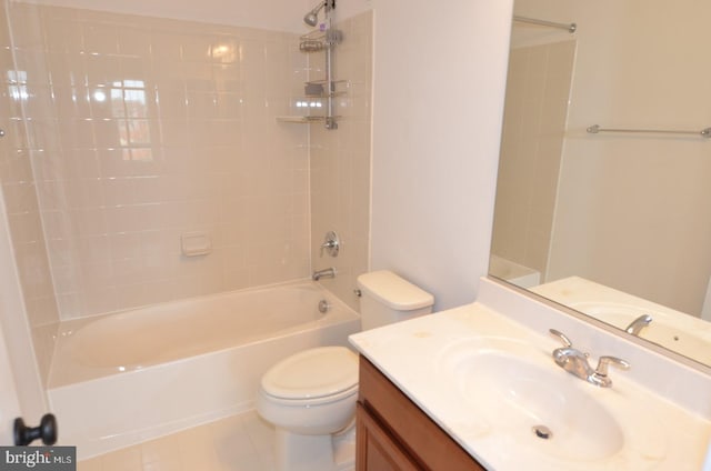 full bathroom featuring tiled shower / bath, vanity, toilet, and tile patterned flooring