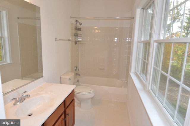 full bathroom with toilet, tiled shower / bath, vanity, and tile patterned floors