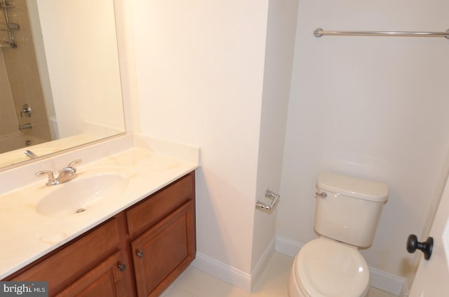 bathroom featuring vanity, toilet, and tile patterned flooring