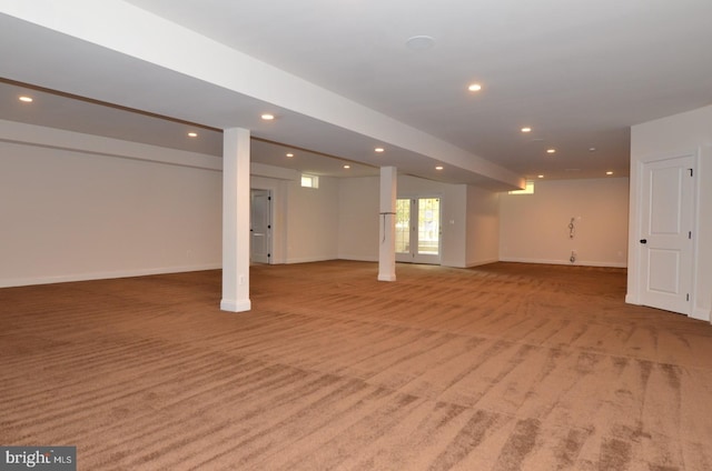 basement featuring light colored carpet