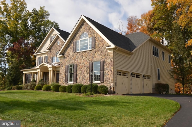 view of front of property with a front yard and a garage