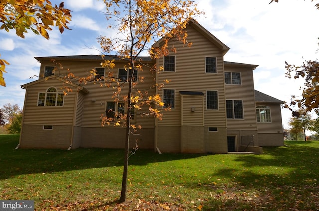 rear view of house with a yard