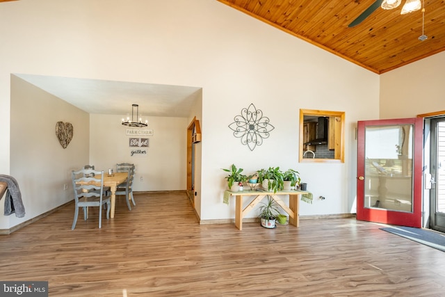 entryway featuring high vaulted ceiling, wooden ceiling, light wood-type flooring, and ceiling fan with notable chandelier