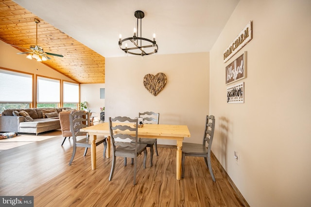 dining area featuring wood ceiling, hardwood / wood-style flooring, ceiling fan with notable chandelier, and vaulted ceiling