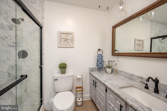 bathroom featuring toilet, walk in shower, vanity, and hardwood / wood-style flooring