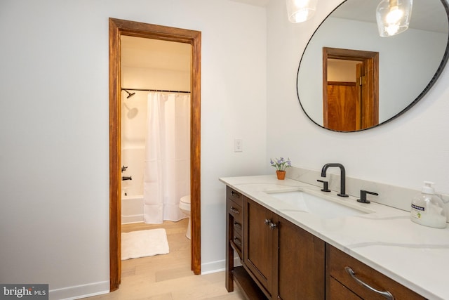 full bathroom featuring vanity, toilet, hardwood / wood-style flooring, and shower / tub combo