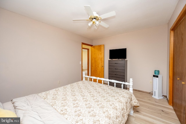 bedroom featuring light hardwood / wood-style flooring, a closet, and ceiling fan