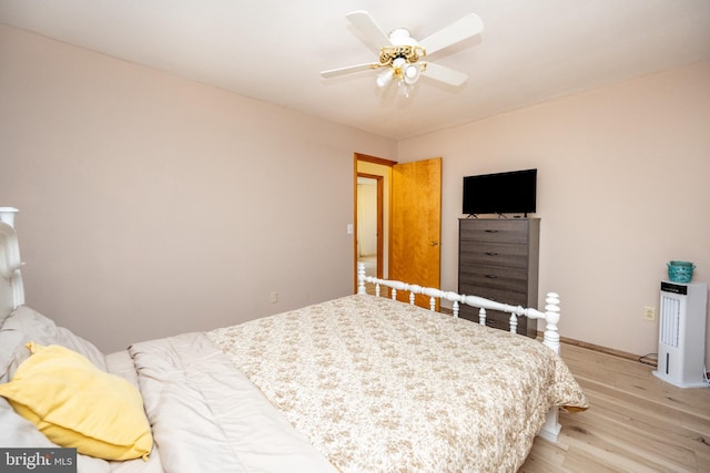 bedroom with light hardwood / wood-style floors and ceiling fan