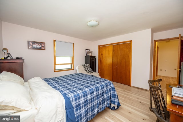 bedroom with light hardwood / wood-style flooring and a closet