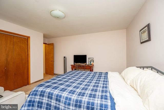 bedroom with a closet and light hardwood / wood-style floors