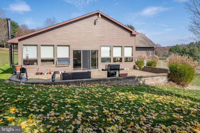 rear view of property with a patio area and a yard