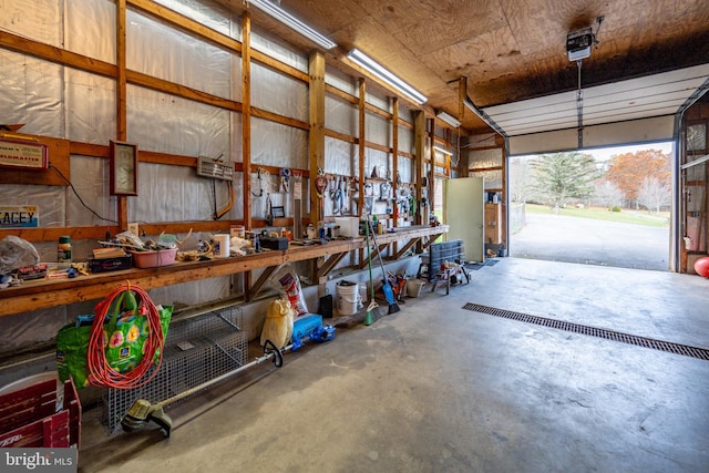 garage with a garage door opener and a workshop area