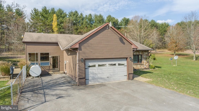 view of front of house with a front yard and a garage