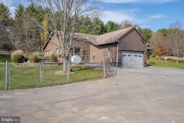 view of front of house with a front yard and a garage