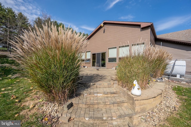 back of house with a patio