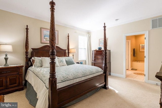 bedroom featuring light carpet, ornamental molding, and ensuite bath