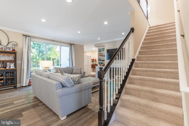 living room featuring hardwood / wood-style flooring and ornamental molding