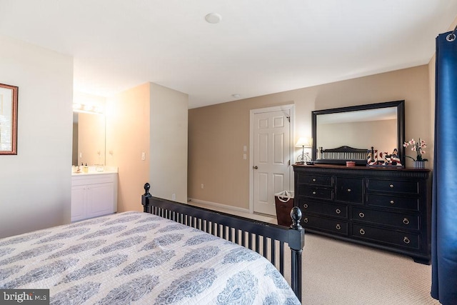 carpeted bedroom featuring connected bathroom