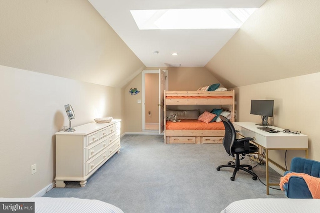 carpeted bedroom featuring lofted ceiling with skylight