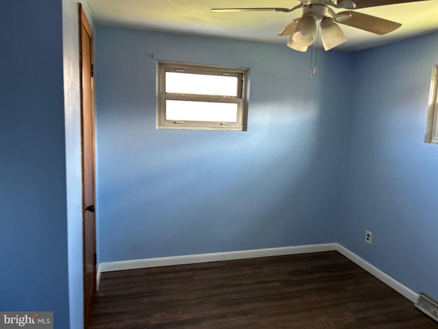 unfurnished room featuring ceiling fan and dark hardwood / wood-style flooring