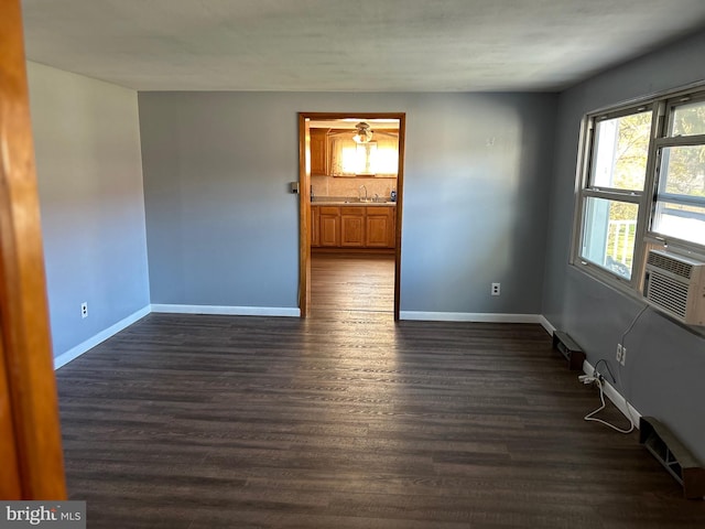 spare room with sink and dark hardwood / wood-style flooring