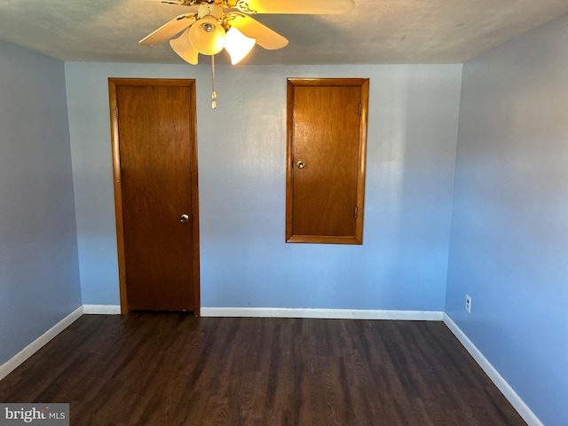 spare room featuring dark hardwood / wood-style floors and ceiling fan