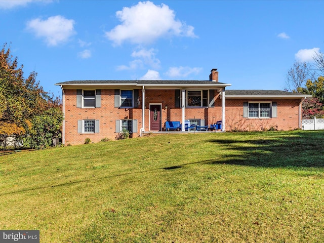 view of front of house with a patio and a front yard