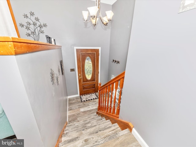 entryway featuring light hardwood / wood-style flooring and a notable chandelier