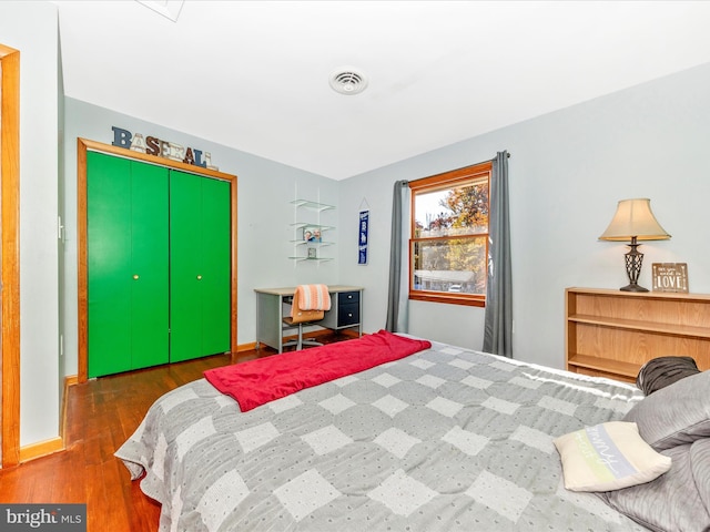 bedroom with a closet and dark hardwood / wood-style flooring