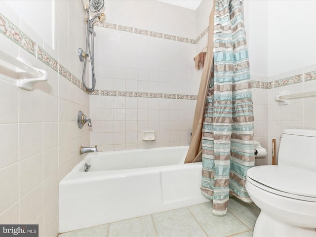 bathroom featuring toilet, tile walls, tile patterned flooring, and shower / tub combo with curtain