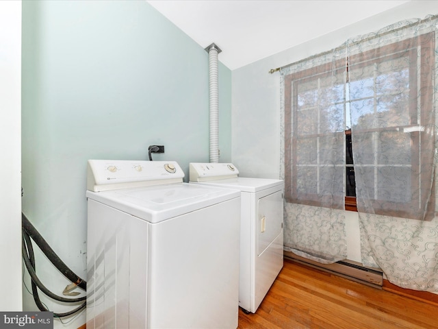 laundry room featuring light hardwood / wood-style floors and separate washer and dryer