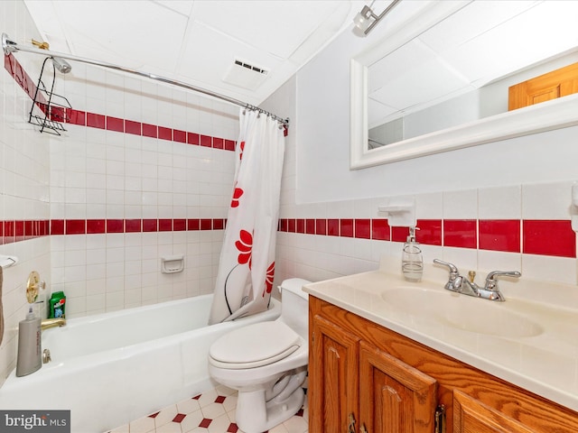 full bathroom with toilet, vanity, shower / bathtub combination with curtain, and tile walls