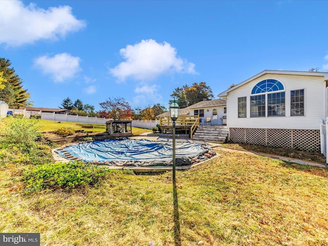 view of pool featuring a yard and a deck