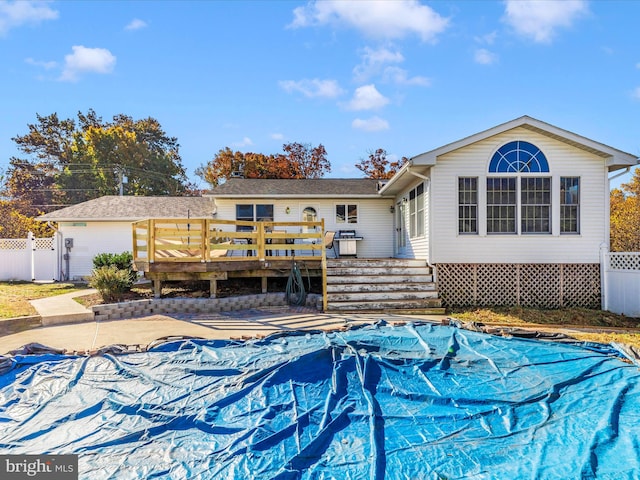 rear view of property with a wooden deck