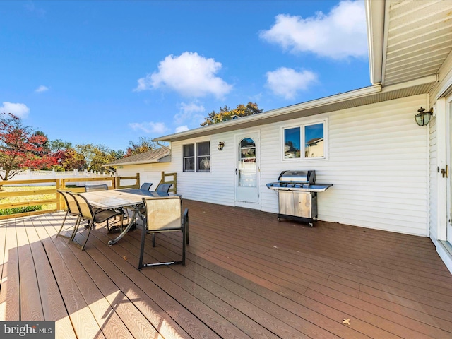 wooden deck featuring a grill