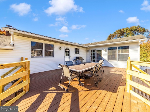 wooden deck featuring a grill