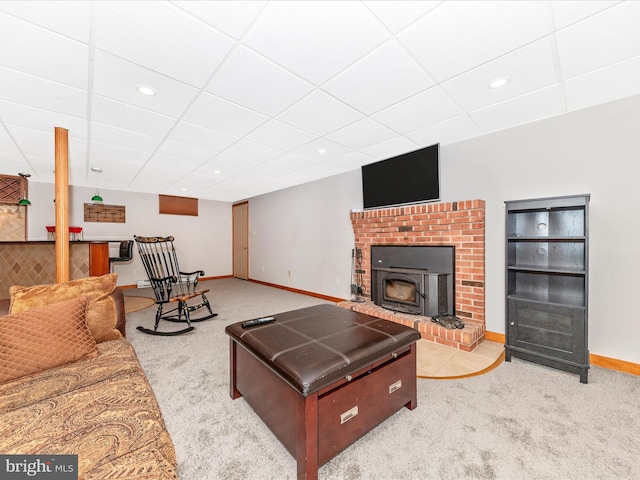 carpeted living room with a drop ceiling