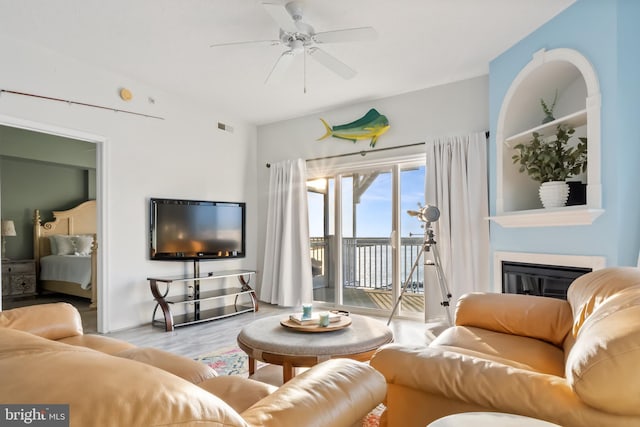 living room featuring light wood-type flooring and ceiling fan