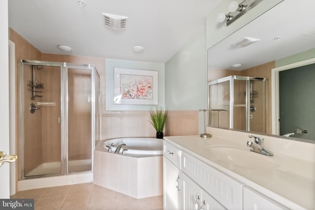 bathroom featuring vanity, independent shower and bath, and tile patterned floors