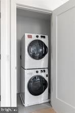 laundry area featuring stacked washing maching and dryer