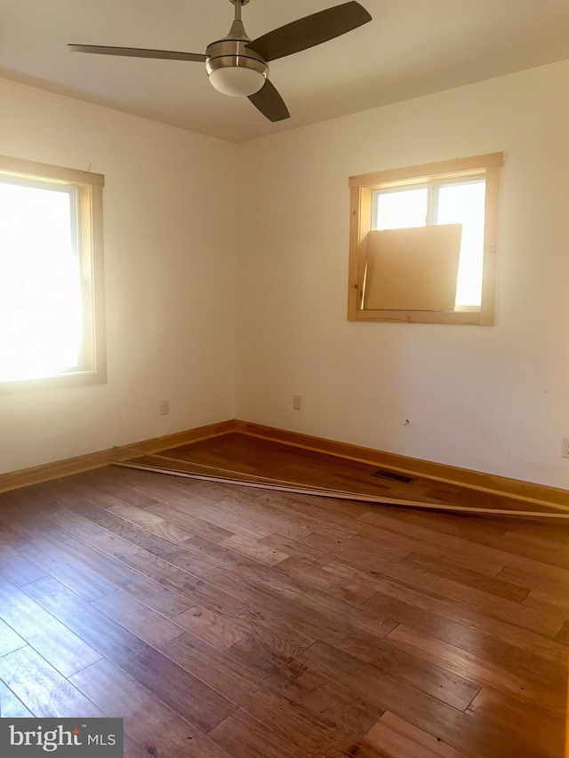 unfurnished room featuring hardwood / wood-style floors and ceiling fan