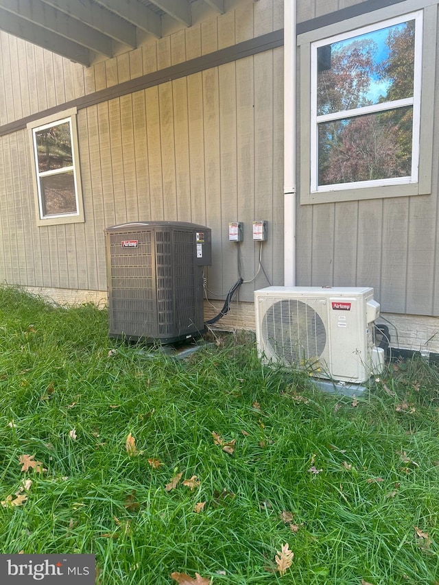 exterior details with central AC, beamed ceiling, wooden walls, and ac unit