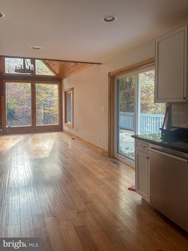 unfurnished living room featuring light hardwood / wood-style floors and lofted ceiling